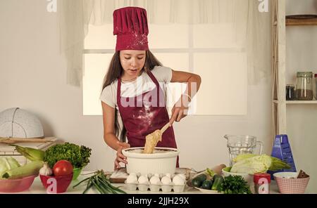 Various menus. kid cooking food in kitchen. choosing a career. little helper baking. culinary and cuisine. happy childhood. happy child wear cook Stock Photo