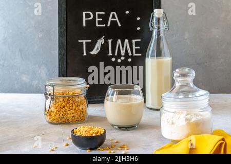 Healthy pea products - milk, flour and seeds. Concrete background, Mockup for text Stock Photo