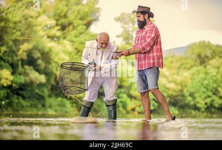 new skills. hobby and recreation. Success. Fishermen. successful catch. fisher celebrate retirement. good production. retired businessman. male Stock Photo