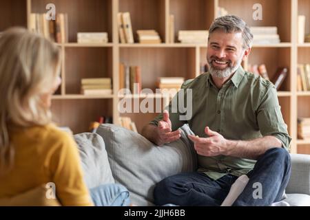 Communication In Marriage. Happy Middle Aged Couple Chatting At Home Stock Photo