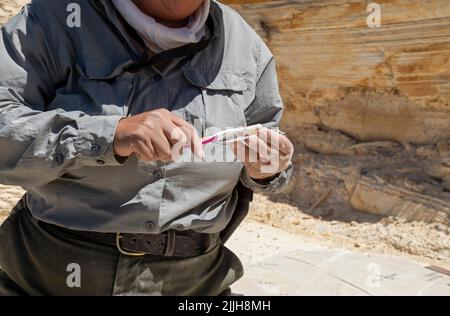 Kemmerer, Wyoming - Fossil Butte National Monument. Dawn Allen-Carlson, a Park Service paleontologist, carefully excavates fossils in a small quarry, Stock Photo