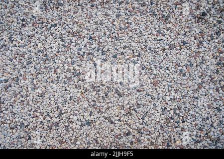 Mixed small gray broken rocks, loose gravel, road construction. Limestone aggregate. Crushed stone background Stock Photo