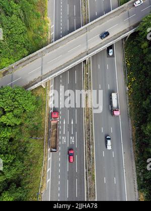 Llantrisant, Wales - July 2022: Aerial view of vehicles on the M4 motorway driving over road markings for lanes to take approaching a junction Stock Photo