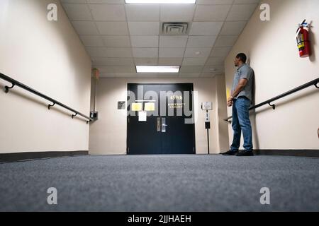 Lone security guard stands outside the entrance of the Bank of England ...
