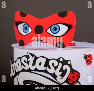 Modern wafer paper cakes. The cakes maked of wafer paper. Design cake in the form of ladybug on a white background. Birthday cake Stock Photo