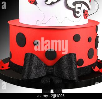 Modern wafer paper cakes. The cakes maked of wafer paper. Design cake in the form of ladybug on a white background. Birthday cake Stock Photo