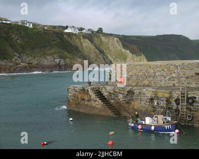 Fishermen on the Harbour Wall at Gorran Haven, Cornwall, UK Stock Photo