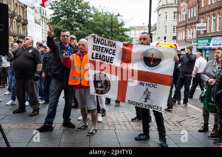 A closeup shot of the people in the English Defense League marching on streets with flags Stock Photo
