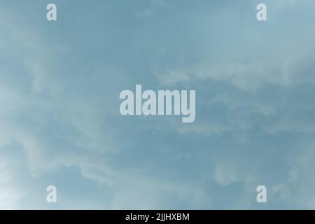 Light gray blue sky solid clouds rain weather change background nature. Stock Photo