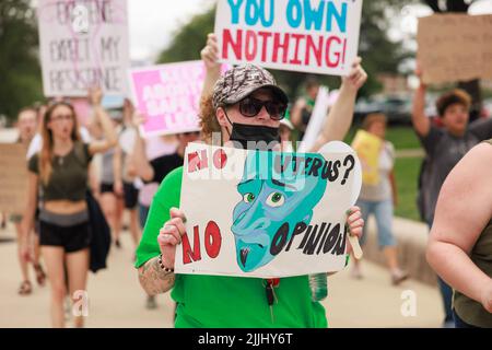 A protester holding a placard saying U.S. war machine: real threat to  peace at a rally against war with Russia sponsored by multiple groups  including CODEPINK: Women for Peace, Black Alliance for