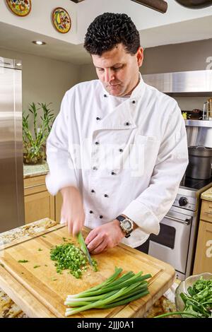 Florida Kendall,Hispanic Latin Latino ethnic immigrant immigrants minority,adult man male,chef makes how to cook video,kitchen cooking cutting celery Stock Photo