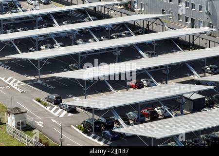 Aerial view of solar panels installed over parking lot with parked cars for effective generation of clean energy Stock Photo