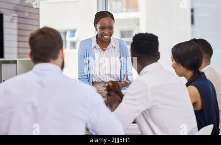 Changing the way we do business. a group of business people brainstorming during a meeting. Stock Photo