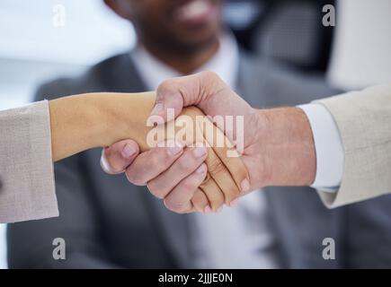 See where good negotiation skills gets you. unrecognisable businesspeople shaking hands in a modern office. Stock Photo