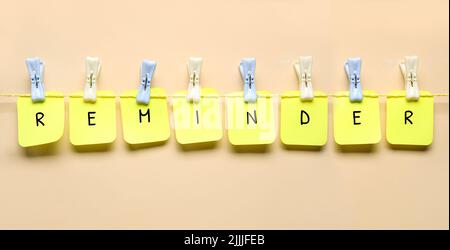 Composition with word REMINDER on beige background Stock Photo