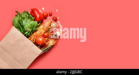 Paper bag with different products on red background with space for text Stock Photo