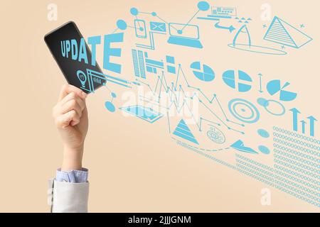 Hand with smartphone on light background. Concept of update Stock Photo