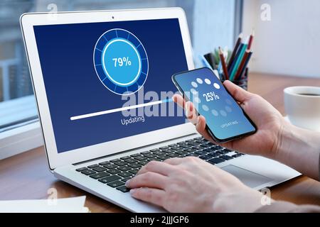 Young woman with laptop and smartphone at table. Concept of update Stock Photo