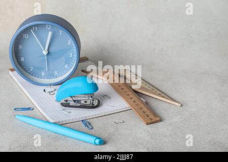 Stapler with stationery supplies on grunge background Stock Photo - Alamy