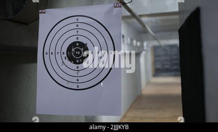 Round target with marked bulls-eye for shooting practice and shots Stock Photo