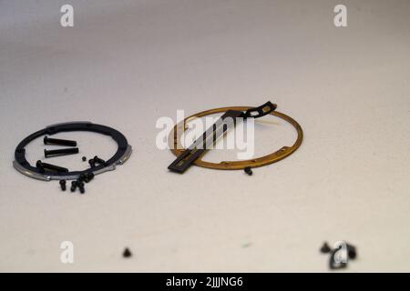 Background with different sizes of bolts, screws and nuts on a neutral surface Stock Photo