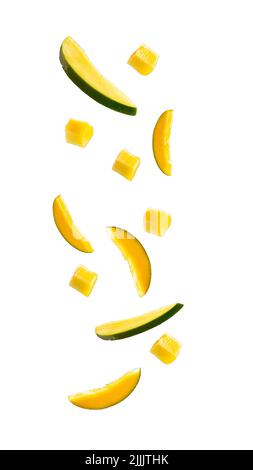 falling mangoes isolated on a white background with a clipping path. cubes of fruit in the air. Stock Photo