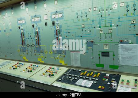 ship engine room dashboard with plenty of bottoms, indicators, small indication lamps and schematics of engines and generators, voltmeters, amperemete Stock Photo