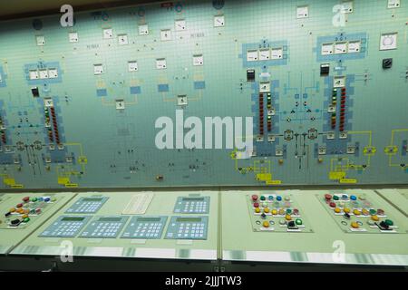 ship engine room dashboard with plenty of bottoms, indicators, small indication lamps and schematics of engines and generators, voltmeters, amperemete Stock Photo