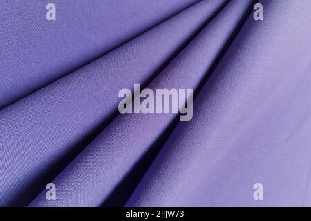 Violet crumpled or wavy fabric texture background. Abstract linen cloth soft waves. Gabardine wool fabric. Merino yarn. Smooth elegant luxury cloth Stock Photo