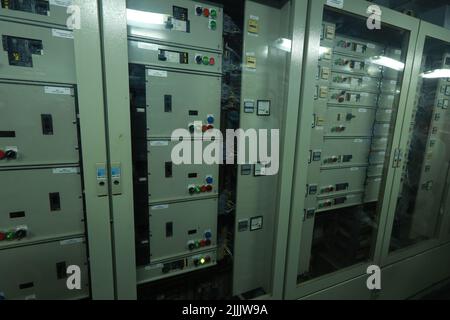 ship engine room dashboard with plenty of bottoms, indicators, small indication lamps and schematics of engines and generators, voltmeters, amperemete Stock Photo