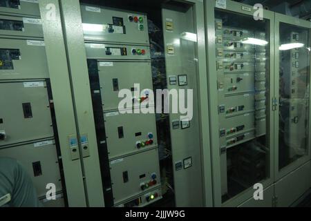 ship engine room dashboard with plenty of bottoms, indicators, small indication lamps and schematics of engines and generators, voltmeters, amperemete Stock Photo