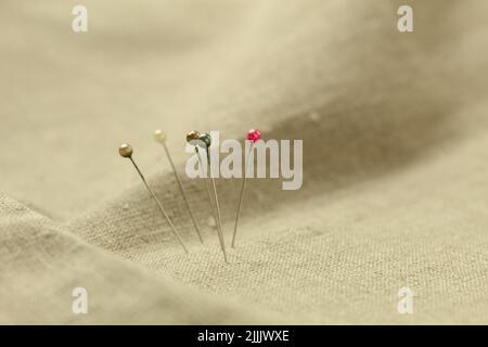 Pins with a round head in different colors, for pattern and sewing. Background with place for text. Close-up Stock Photo