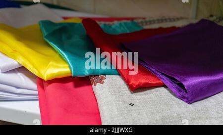 Multicolored kitchen towels lie folded on a shelf Stock Photo