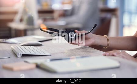 Lets get to work. an unrecognizable call center agent at work. Stock Photo