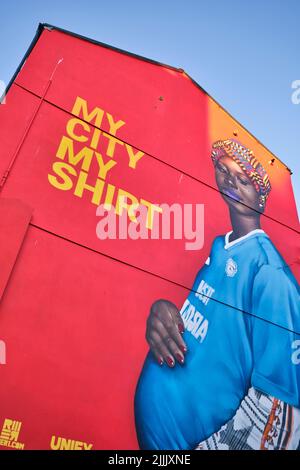 A huge, painted mural on a building, featuring a pregnant woman, proudly saying Cardiff is her city. In Cardiff, Wales, United Kingdom. Stock Photo