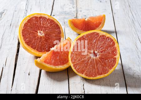 Fresh grapefruit slices on wooden table Stock Photo