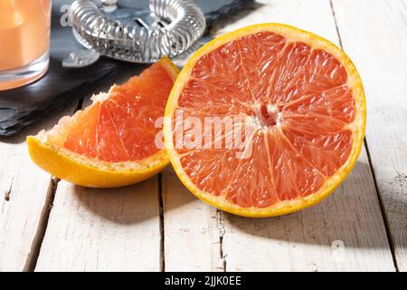 Fresh grapefruit slices on wooden table Stock Photo