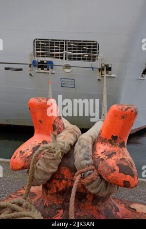 Bollard holding mooring ropes of the Emerald Princess cruise ship moored alongside the heritage centre in Cobh, County Cork, Ireland, July 2022 Stock Photo