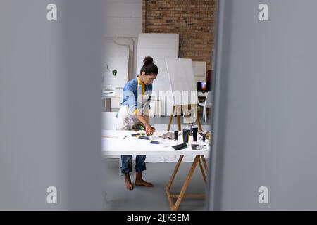 Image of biracial female artist working in studio Stock Photo - Alamy