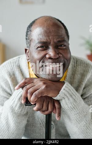 Portrait of African happy senior man with stick smiling at camera Stock Photo