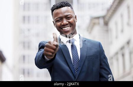 Early mornings get you the success you want. a young businessman showing a thumbs up in the city. Stock Photo