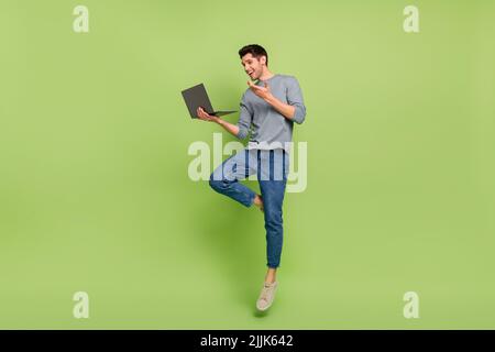 Full body photo of cheerful businessman have video meeting with his colleagues isolated on green color background Stock Photo