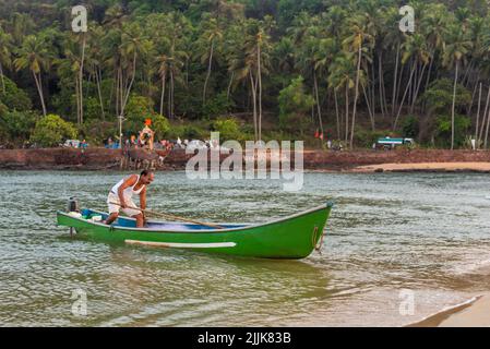 A local Indian fisherman in a boat in the village of Betul, Salcete, Goa, India Stock Photo