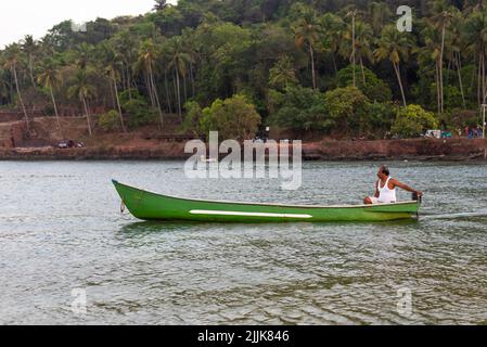 A local Indian fisherman in a boat in the village of Betul, Salcete, Goa, India Stock Photo