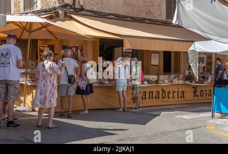 Santanyi, Spain; july 09 2022: Street weekly market in the Mallorcan town of Santanyi. Stall selling bread and sweets typical of the island of Mallorc Stock Photo