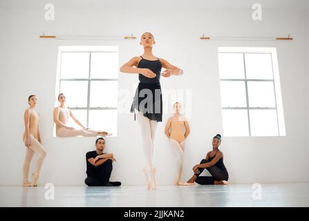 To dance is to be out of yourself. a group of ballet dancers practicing a routine in a dance studio. Stock Photo