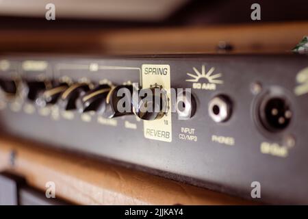 Guitar amp with reverb switch and inputs in focus. Stock Photo