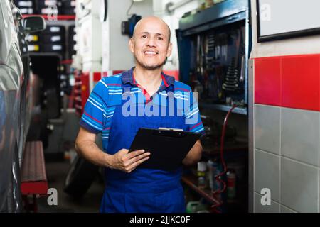 Adult cheerful technician man in coveralls Stock Photo