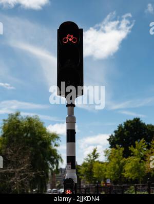 Traffic light that is on red for cyclists in Haarlem, the Netherlands. There are no people or trademarks in the shot. Stock Photo