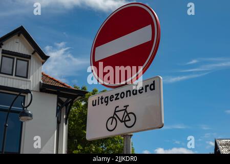 One-way traffic sign with an exception for cyclists in the Netherlands. There are no people or trademarks in the shot. Stock Photo